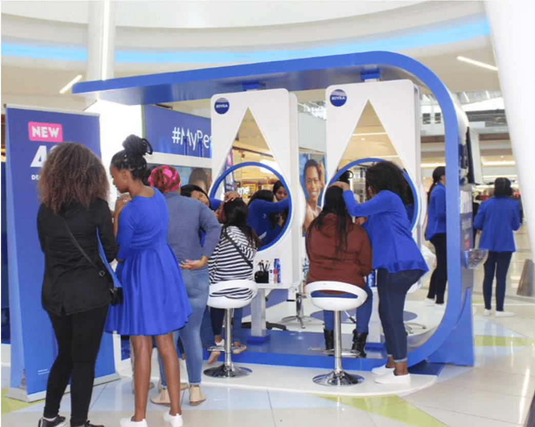 Shoppers visiting a Nivea brand activation stand in a mall
