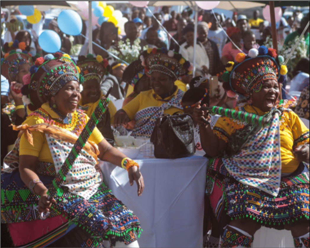 Crowd in traditional dress celebrating at a community event
