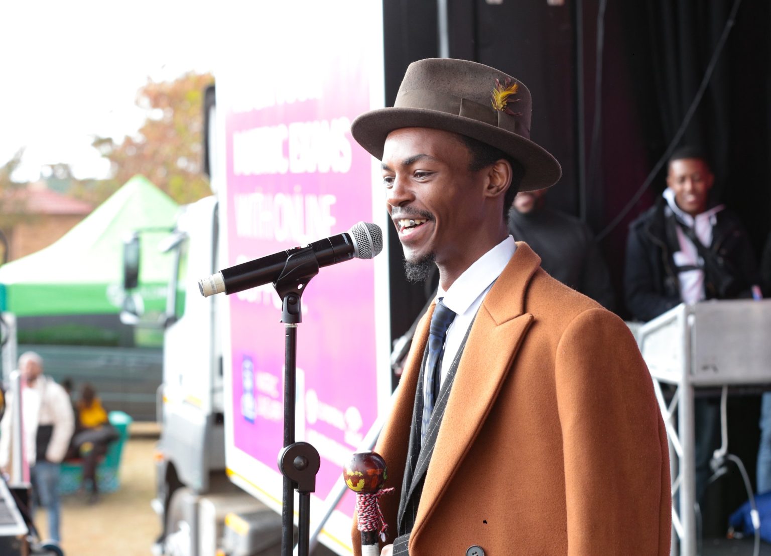 Presenter speaking at the microphone at a community event